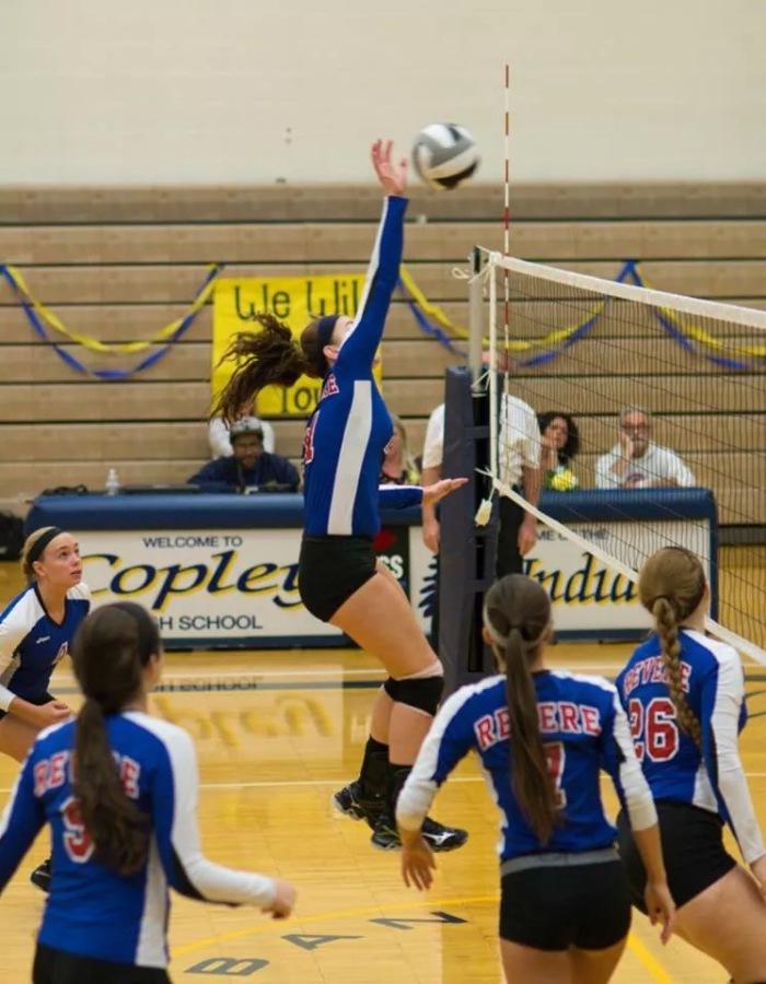 Victoria Farian jumps to spike the ball.