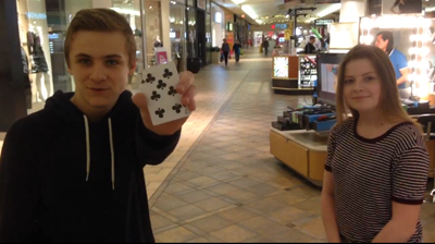Sedlacek performs magic for a patron of Summit Mall