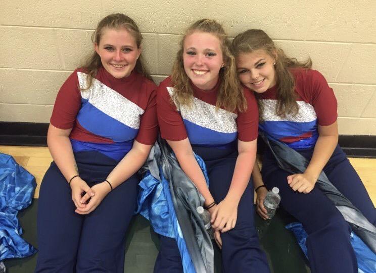 Nadzam, Brenna Ryan and Amanda Jarrell pose in their flag line uniforms. 