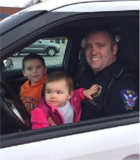 Officer Shaffer poses with his children.