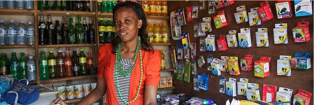 A woman displays her hard work sitting in her shop in Uganda.