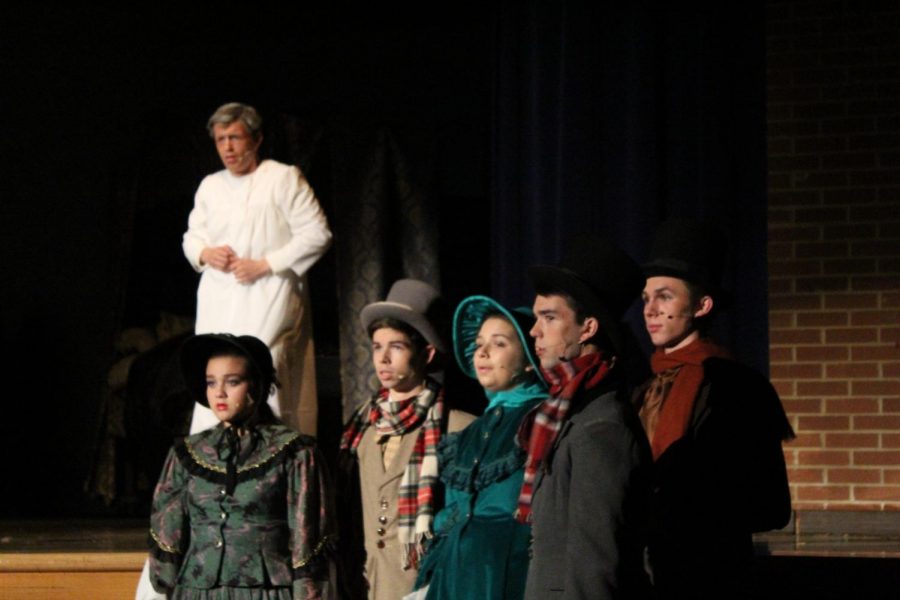 Narrators from left to right: Molly Oldham, William Marchetta, Sasha Desberg, Tylor Davis and Eric Dye with lead Joe Restivo as Ebenezer Scrooge