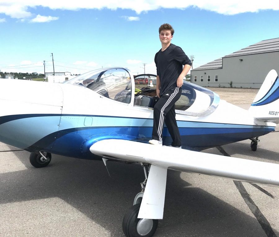 Zach Spatz poses by his plane. 