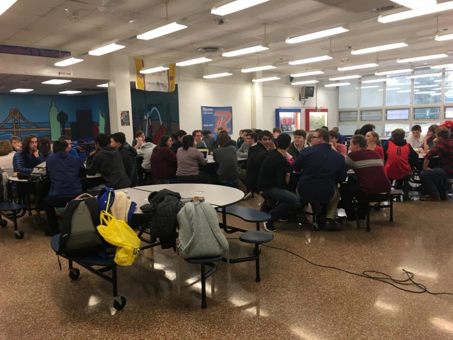 Students converse at different tables in the middle ground event, which was held in the cafeteria on February 14.