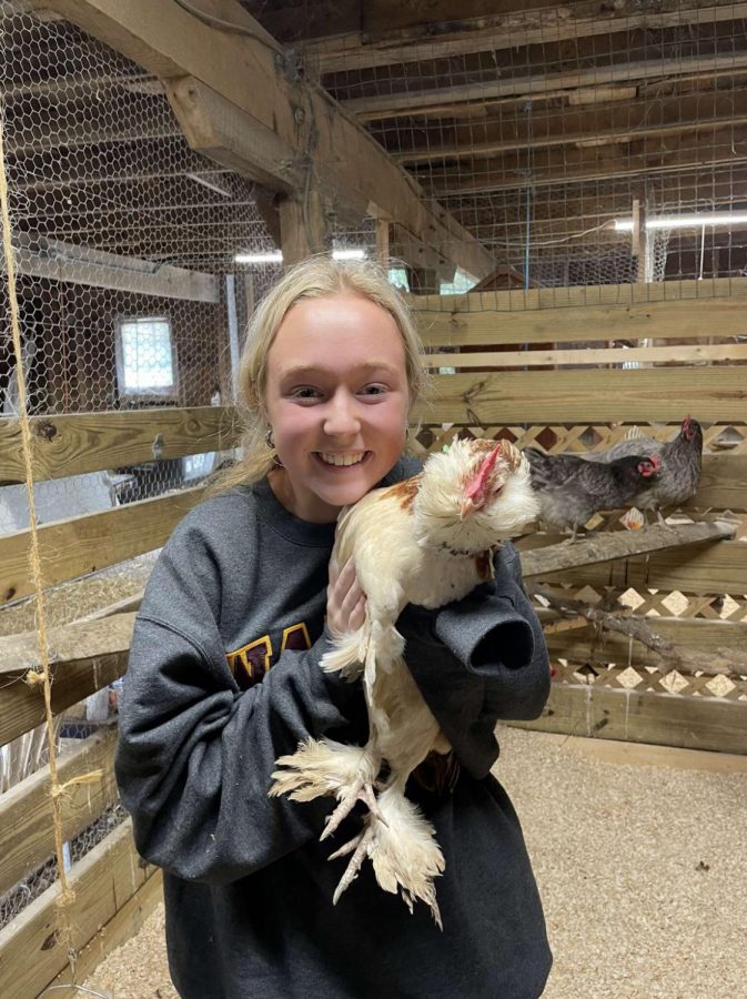 Hudnall poses with one of her chickens.