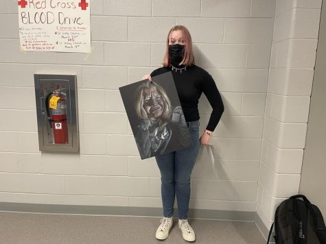 Grandon poses with her art project.