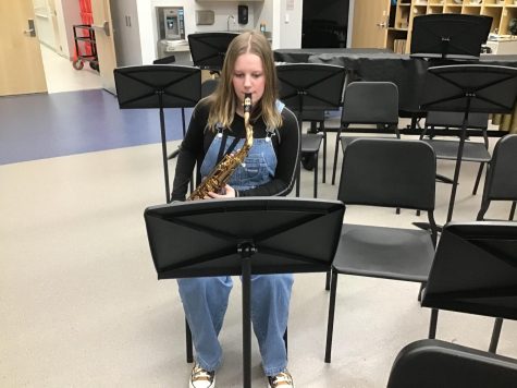Keaton practices her instrument in the band room. 