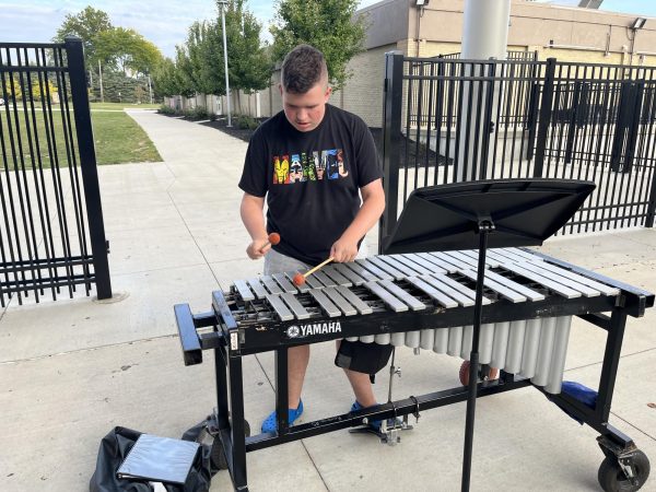Rich plays his vibraphone at band rehearsal. 
