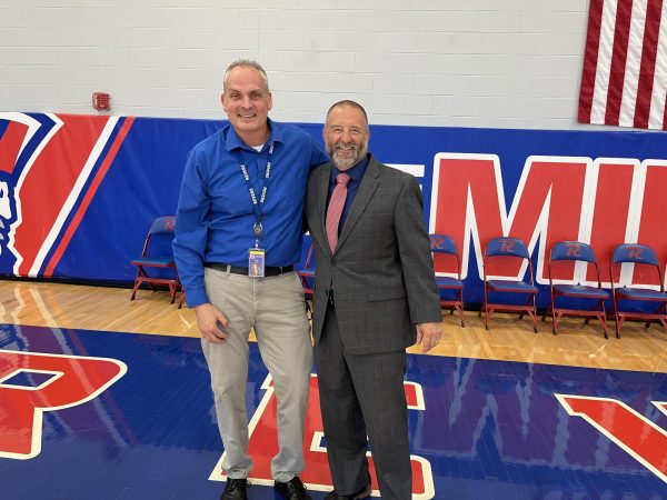 Principals Dr. Andy Peltz and Doug Faris stand together in the RHS gymnasium, 