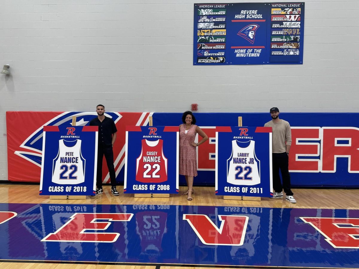 Casey, Larry Jr. and Pete Nance stand beside their signs. 