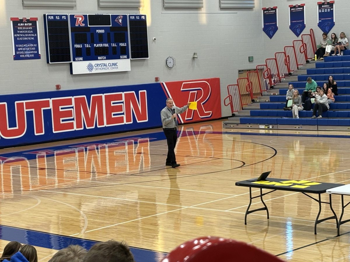 Principal Doug Faris gives students information of the pSAT during an assembly