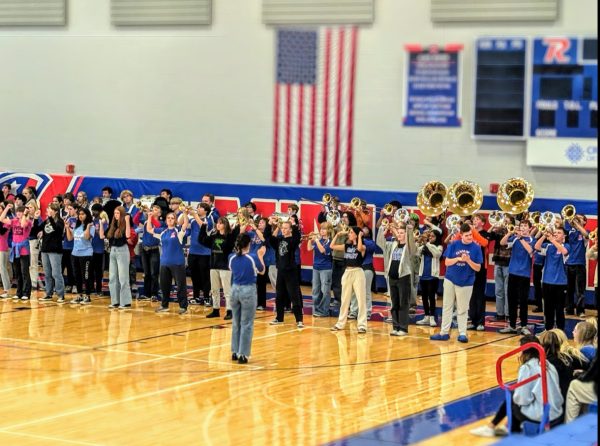 The RHS Marching Band performs at a pep rally in the gymnasium. 