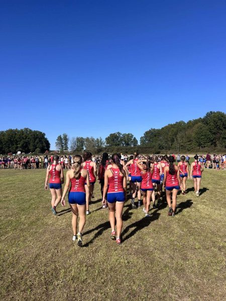 Revere High School Women’s cross country team runs together at a race.