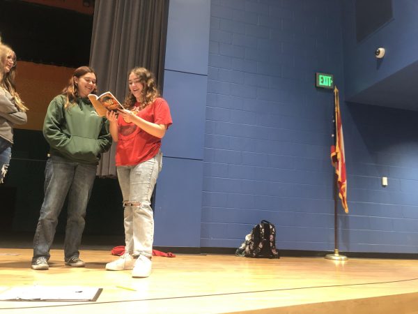 Evie Brackett stands with Revere Players members and reads the Treasure Island script. 