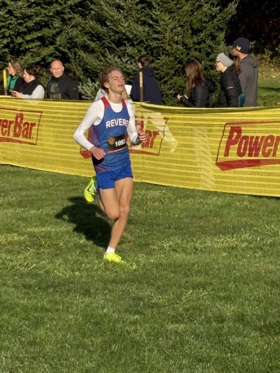 Wells strains toward the finish line during a cross country meet.