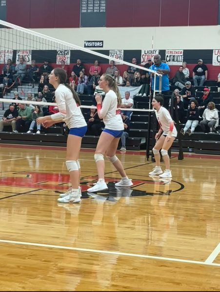 Regula, Linderbaum and Milicia on the floor during a varsity match against Kent Roosevelt High School.