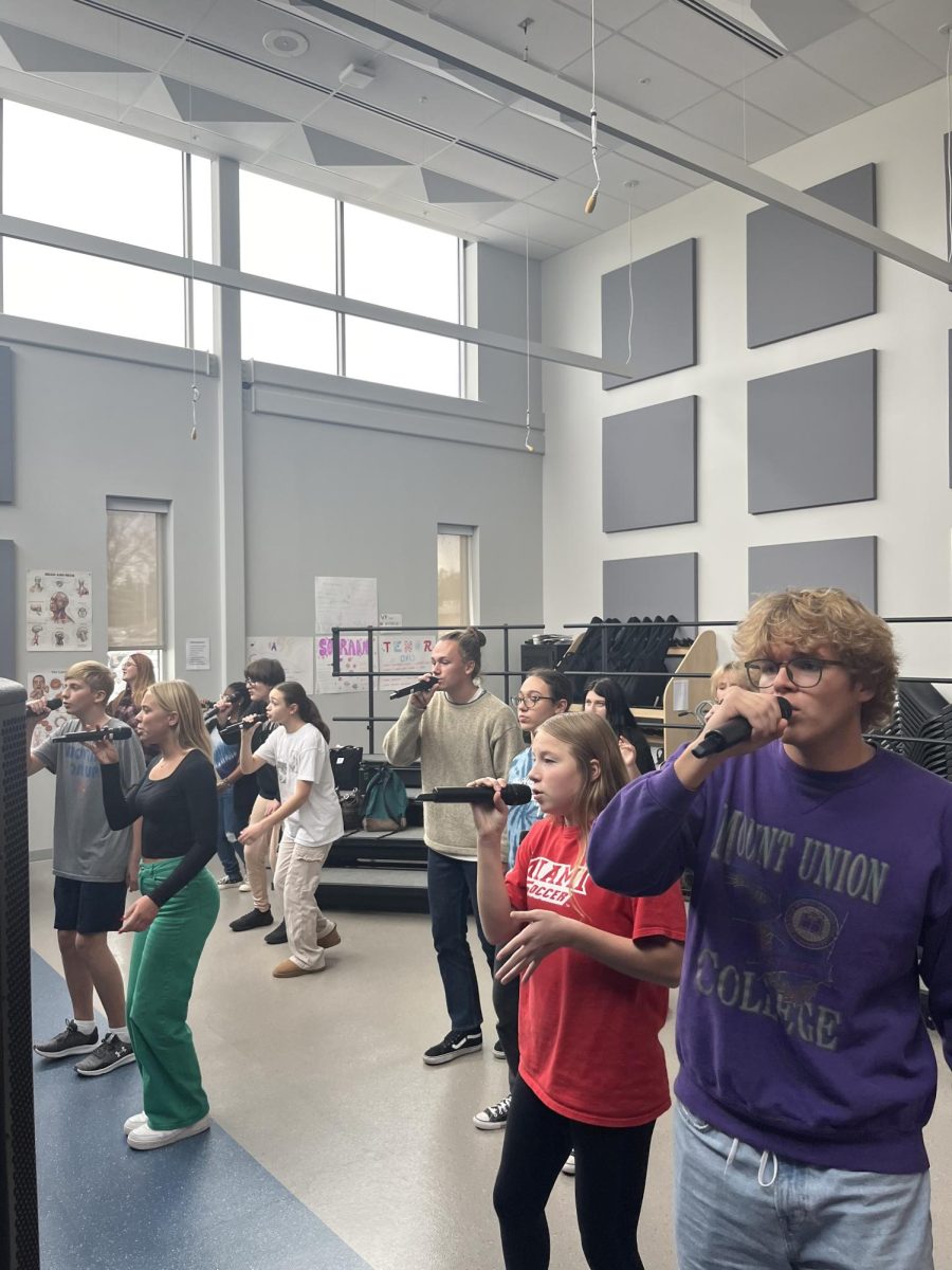 Reverse sings in the RHS choir room practicing for their performance. 