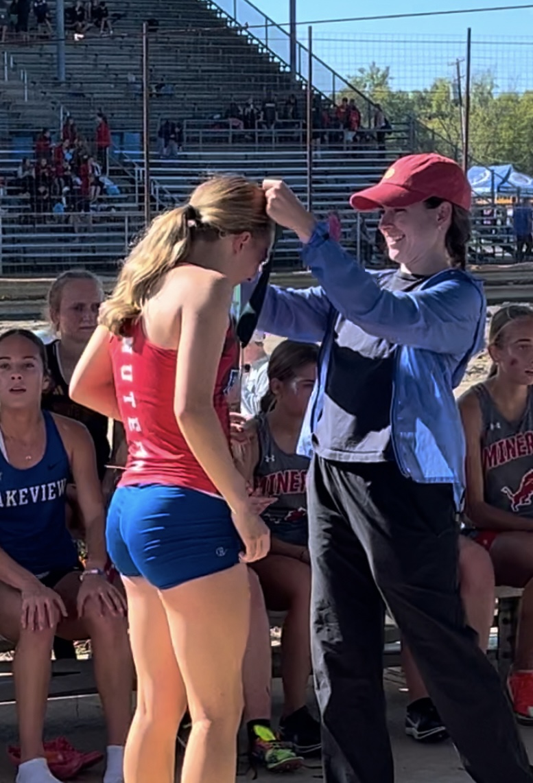 Caroline Wilson receives a medal while on the Revere High School cross country team