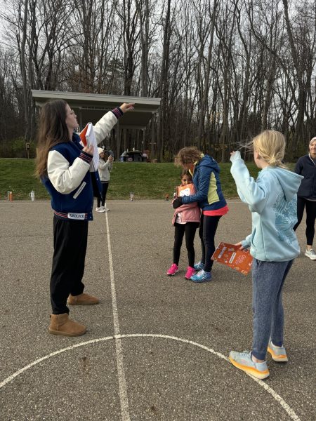 Siedlecki coaching Bath Elementary School students on their basketball court. 