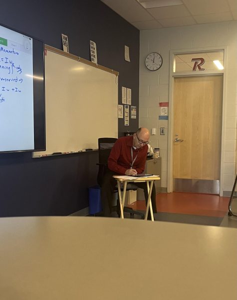 Shane sits at the front of his science classroom at RHS. 