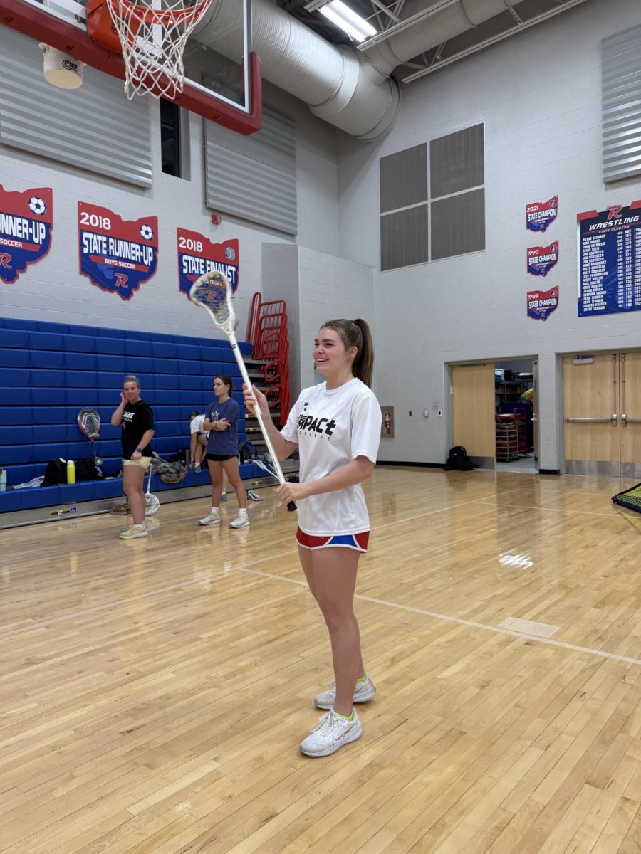 Huffman plays lacrosse in the Revere High School gymnasium. 