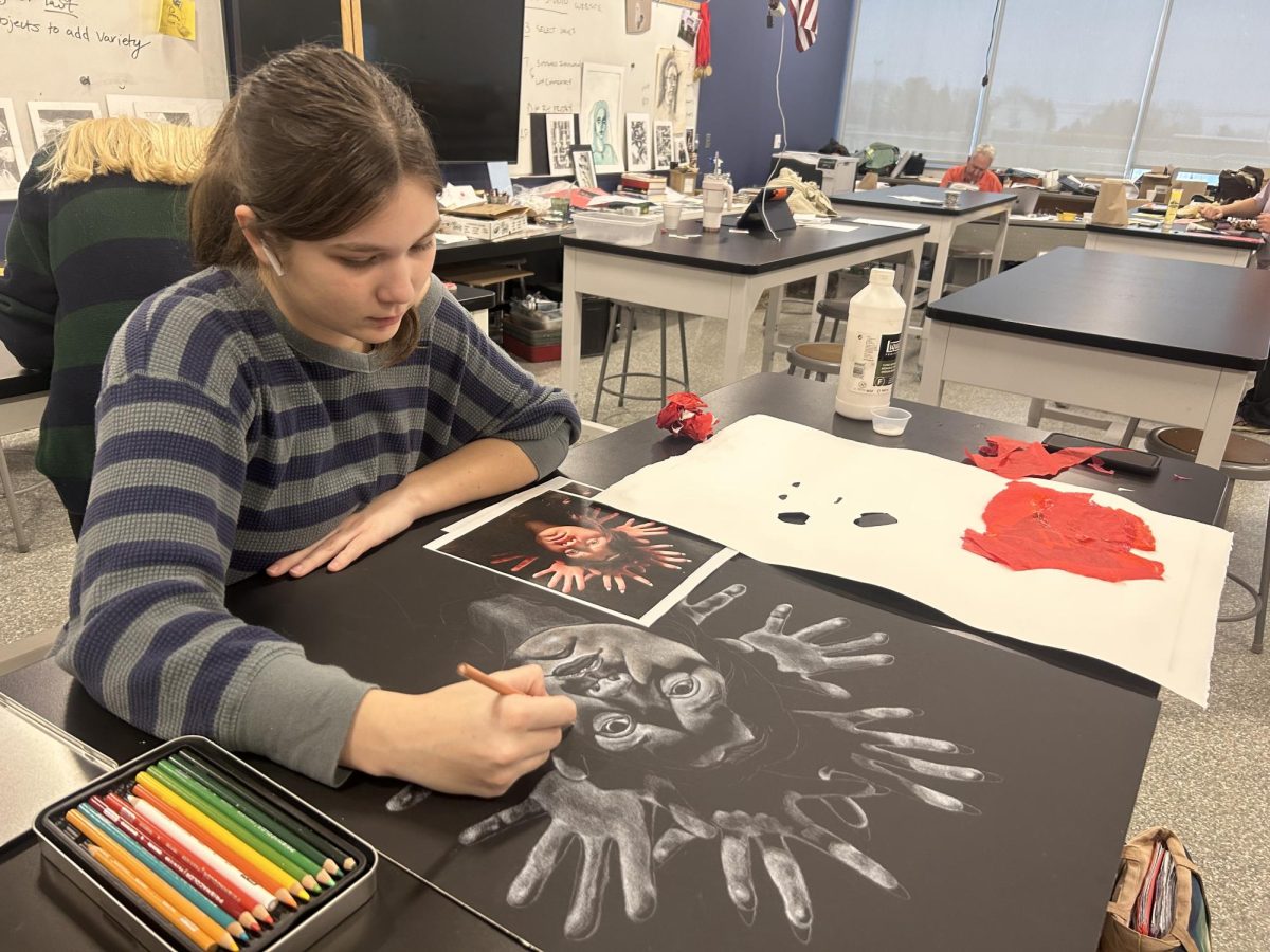 Gardner works on a drawing in her AP art class. 