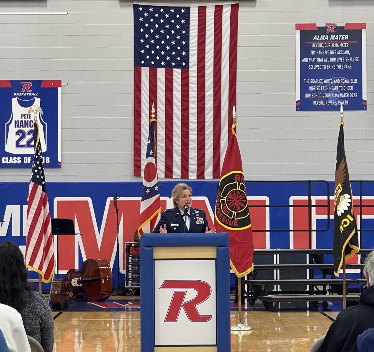 The 2025 guest speaker Colonel Shannon Juby stands before the school. 