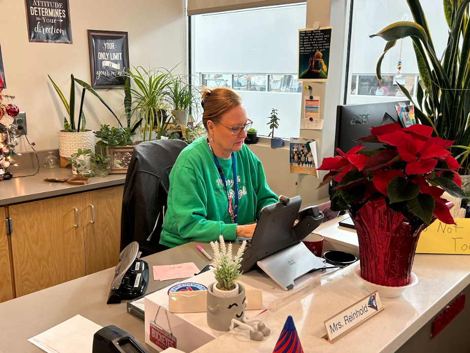 Administrative Assistant to the counseling office Terri Reinhold works at her desk.